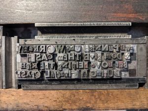 Image of letterpress type arranged in the forme ready for printing.